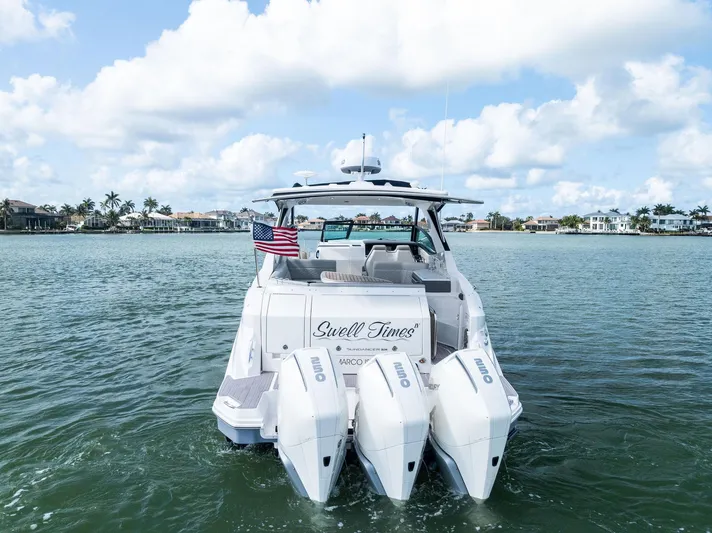 Swelltimes IV Yacht Photos Pics 2022 Sea Ray Sundancer 320 OB boat on water, rear view with triple outboard engines.