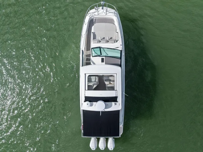 Swelltimes IV Yacht Photos Pics 2022 Sea Ray Sundancer 320 OB boat on green water, aerial view.