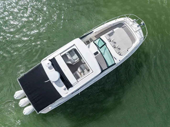 Swelltimes IV Yacht Photos Pics 2022 Sea Ray Sundancer 320 OB boat on water, aerial view.