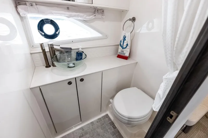 Swelltimes IV Yacht Photos Pics 2022 Sea Ray Sundancer 320 OB bathroom with modern fixtures and nautical decor.