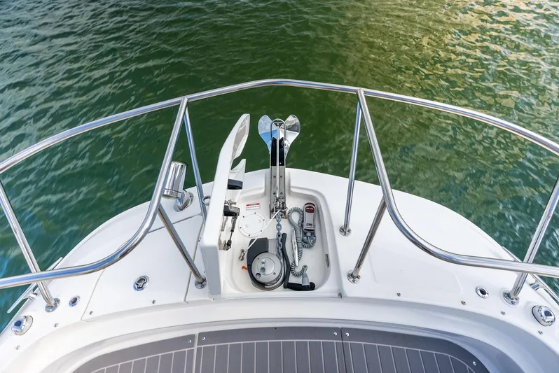 Swelltimes IV Yacht Photos Pics 2022 Sea Ray Sundancer 320 OB bow with anchor and railing on calm water.