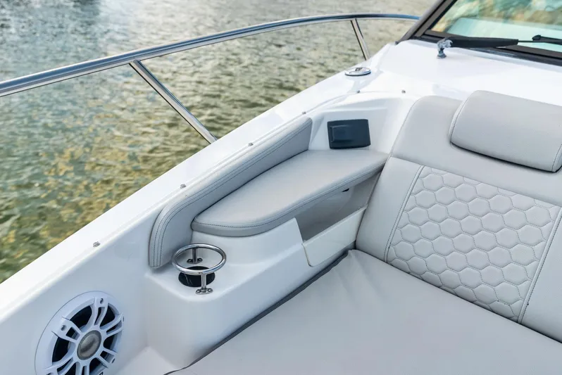 Swelltimes IV Yacht Photos Pics 2022 Sea Ray Sundancer 320 OB interior with luxurious seating and cup holder by the water.