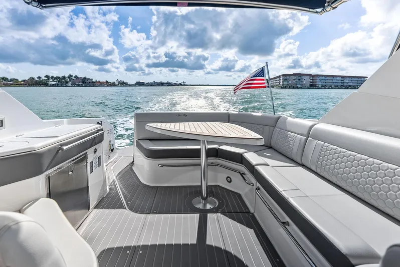 Swelltimes IV Yacht Photos Pics 2022 Sea Ray Sundancer 320 OB boat interior with seating, table, and ocean view.