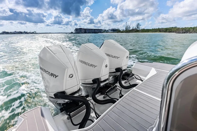 Swelltimes IV Yacht Photos Pics 2022 Sea Ray Sundancer 320 OB with triple Mercury outboard engines cruising on a sunny day.