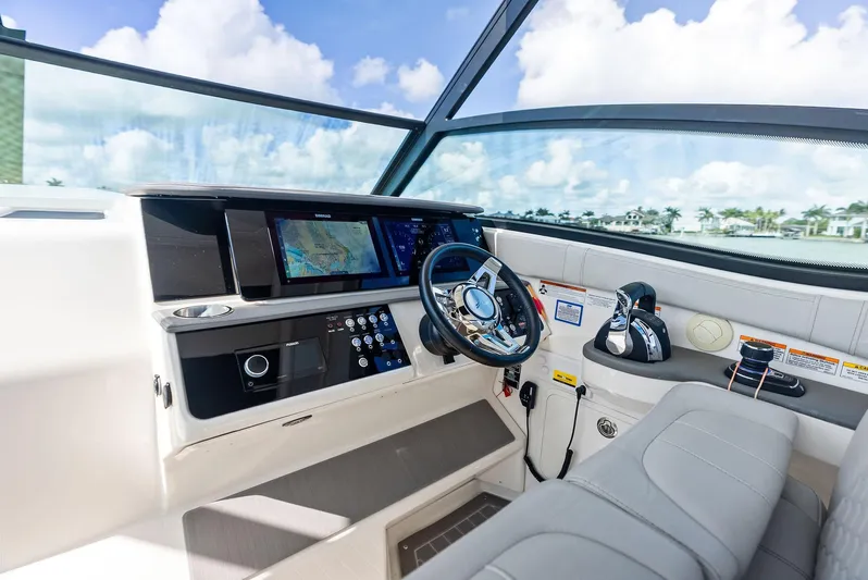 Swelltimes IV Yacht Photos Pics Cockpit of 2022 Sea Ray Sundancer 320 OB with modern navigation system and steering wheel.