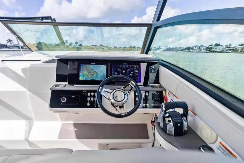 Swelltimes IV Yacht Photos Pics 2022 Sea Ray Sundancer 320 OB helm with modern navigation displays and controls.
