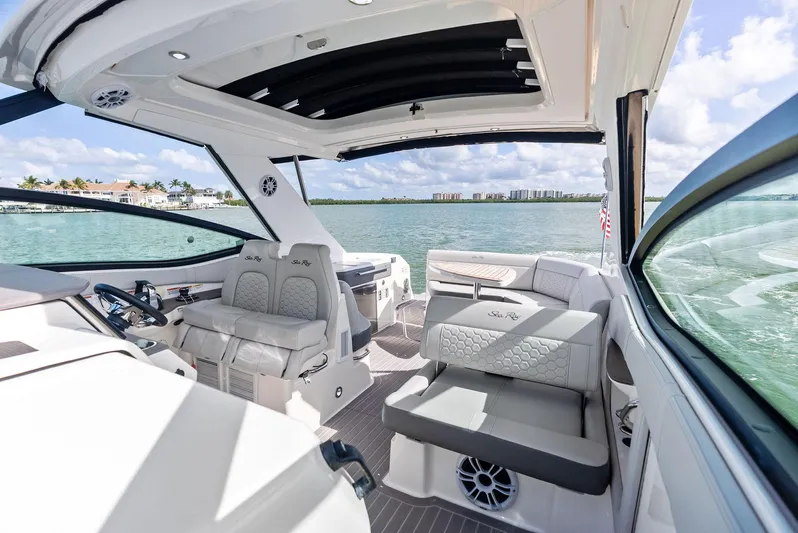 Swelltimes IV Yacht Photos Pics 2022 Sea Ray Sundancer 320 OB interior with luxurious seating and scenic water view.