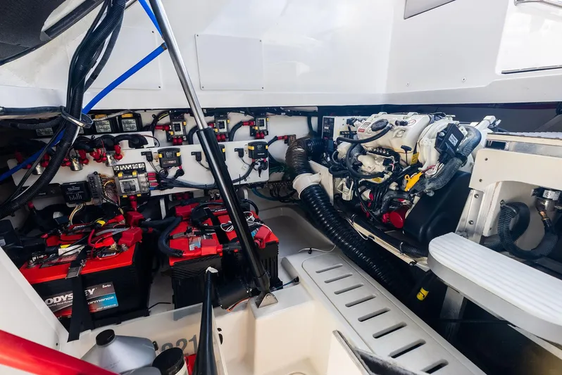 Swelltimes IV Yacht Photos Pics Engine compartment of 2022 Sea Ray Sundancer 320 OB, showcasing batteries and mechanical components.