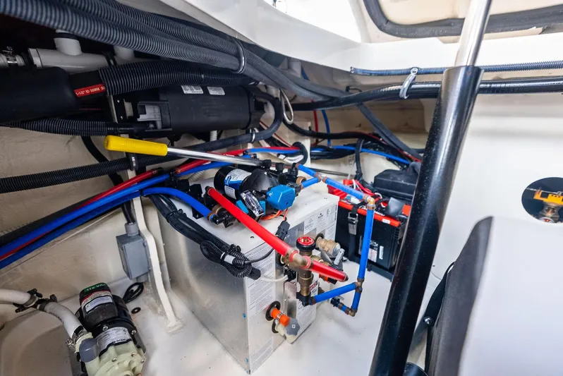 Swelltimes IV Yacht Photos Pics Engine compartment of 2022 Sea Ray Sundancer 320 OB with visible wiring and components.