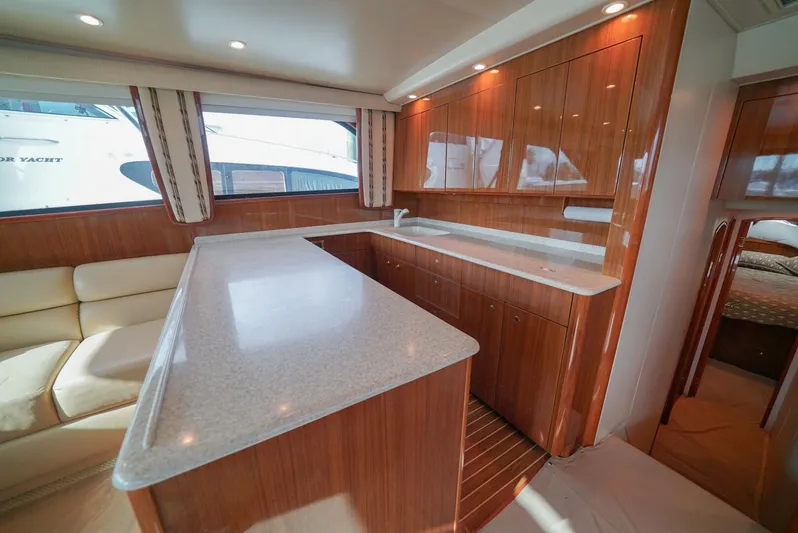 Bad Habits Yacht Photos Pics Luxurious interior of 2007 Viking 45 Convertible yacht with modern kitchen and seating area.