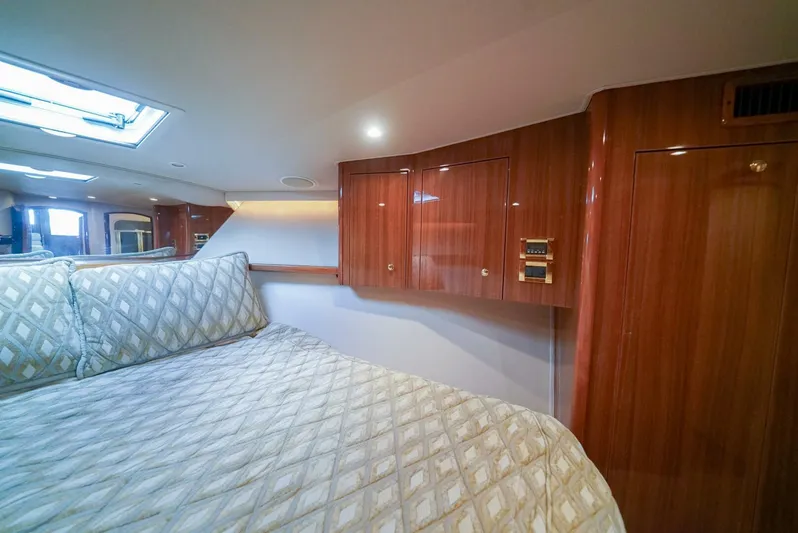 Bad Habits Yacht Photos Pics Luxurious bedroom interior of 2007 Viking 45 Convertible yacht with wood cabinetry and skylight.