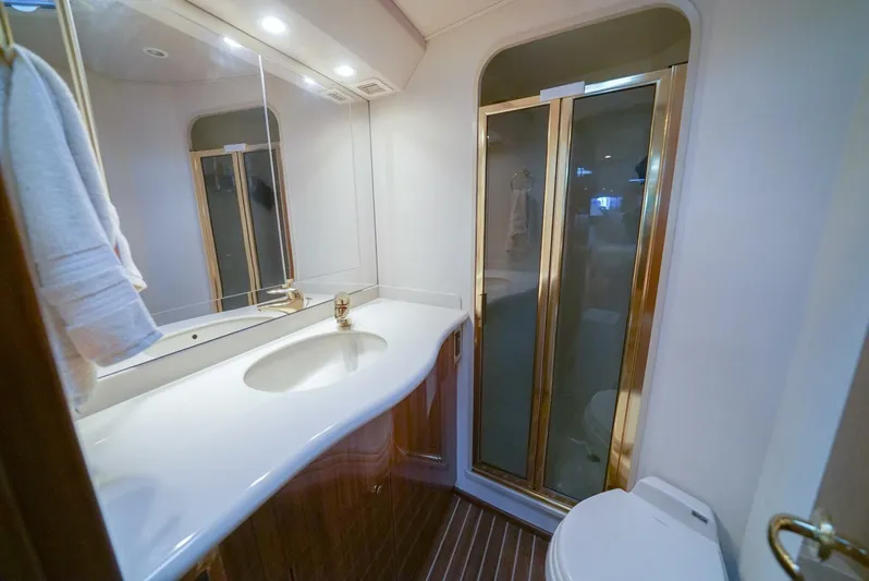 Bad Habits Yacht Photos Pics Luxurious bathroom in 2007 Viking 45 Convertible yacht with elegant fixtures and shower.