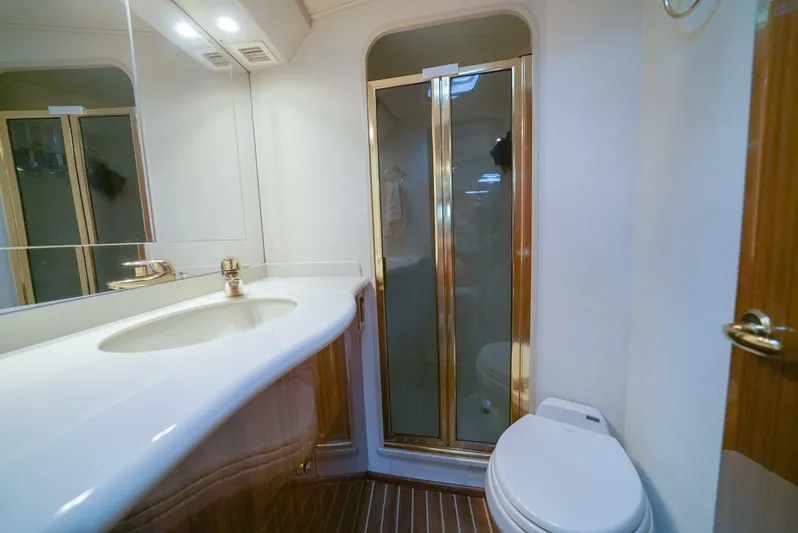 Bad Habits Yacht Photos Pics Luxurious bathroom in 2007 Viking 45 Convertible yacht with shower and elegant fixtures.