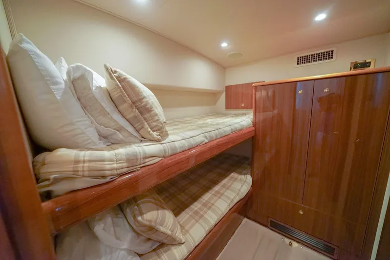Bad Habits Yacht Photos Pics Bunk beds in 2007 Viking 45 Convertible yacht cabin with wooden cabinetry and plaid bedding.