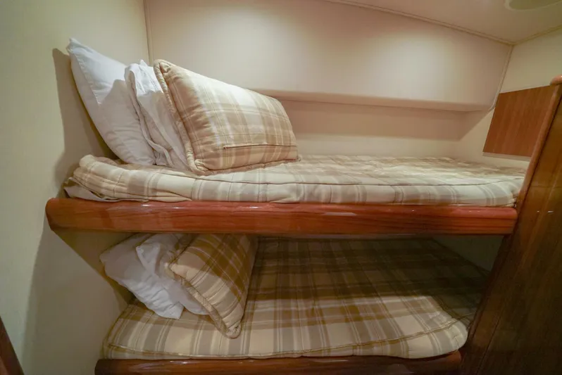 Bad Habits Yacht Photos Pics Bunk beds with plaid bedding in a 2007 Viking 45 Convertible yacht cabin.