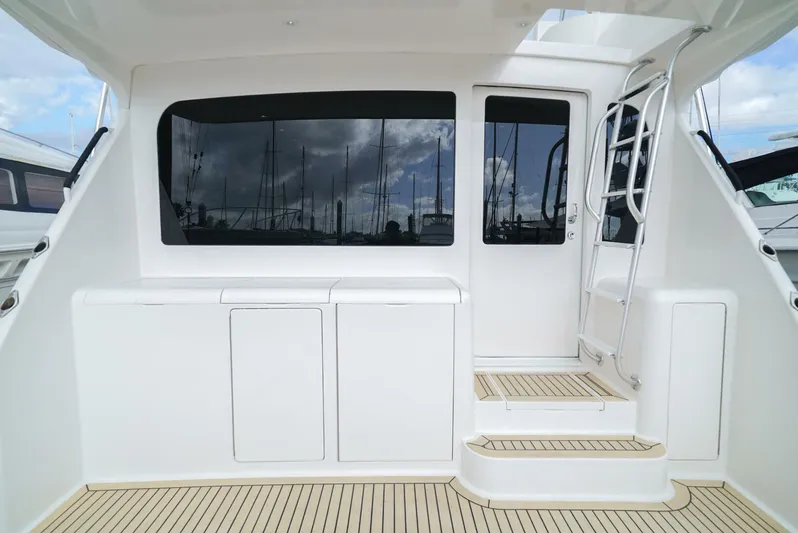 Bad Habits Yacht Photos Pics 2007 Viking 45 Convertible yacht deck with steps and window, showcasing sleek design.