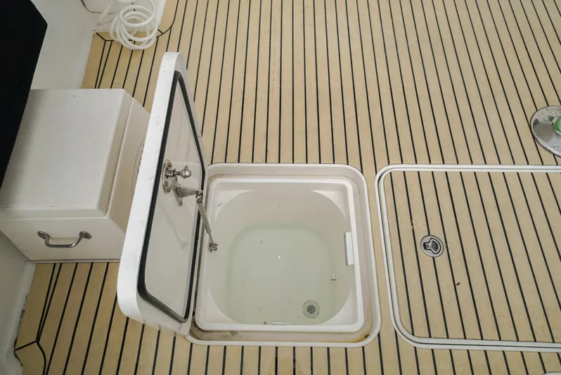 Bad Habits Yacht Photos Pics Open hatch on 2007 Viking 45 Convertible boat deck with striped flooring.