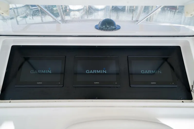 Bad Habits Yacht Photos Pics Three Garmin displays on a 2007 Viking 45 Convertible boat dashboard.