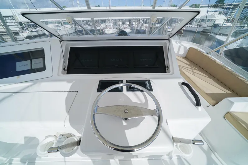 Bad Habits Yacht Photos Pics 2007 Viking 45 Convertible yacht helm with steering wheel and navigation displays.