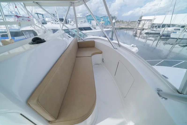 Bad Habits Yacht Photos Pics 2007 Viking 45 Convertible yacht with beige seating, docked at a marina.