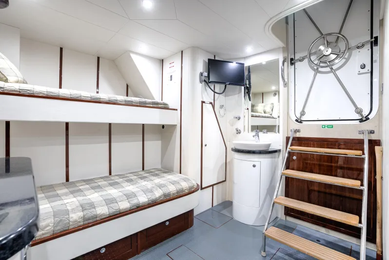 Family Tradition II Yacht Photos Pics Interior of 2012 Neptunus 750FX yacht with bunk beds, TV, and stairs.
