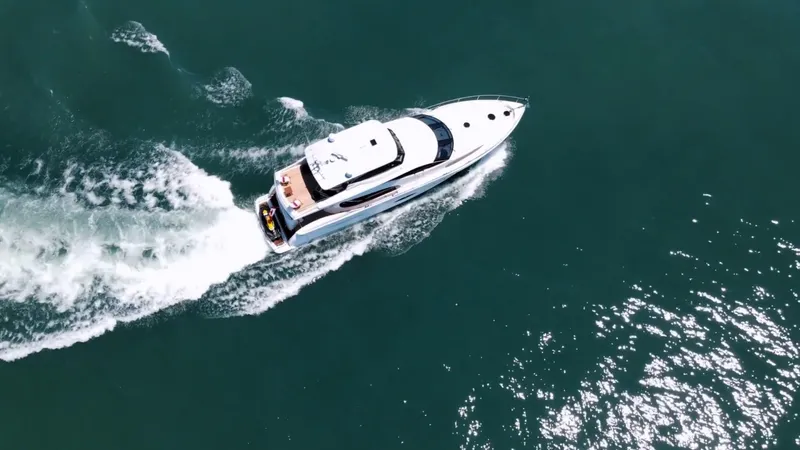 Family Tradition II Yacht Photos Pics Aerial view of 2012 Neptunus 750FX yacht cruising on open water.