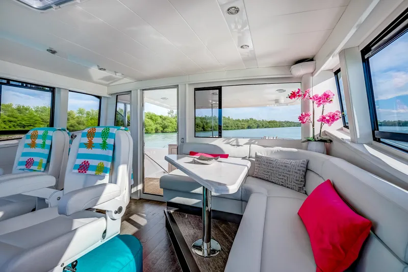 Family Tradition II Yacht Photos Pics Luxurious Neptunus 750FX yacht interior with modern seating, vibrant decor, and scenic water views.