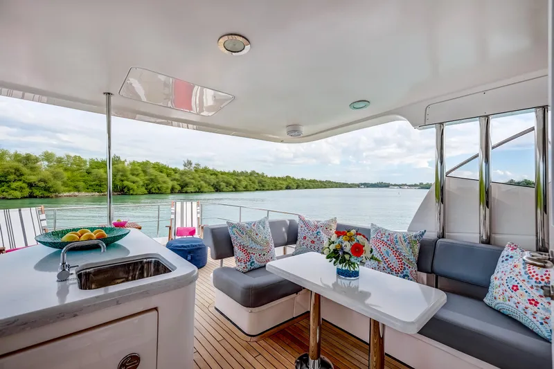 Family Tradition II Yacht Photos Pics Luxurious Neptunus 750FX yacht interior with elegant seating and scenic water view.