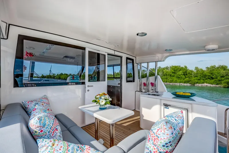 Family Tradition II Yacht Photos Pics Luxurious 2012 Neptunus 750FX yacht interior with plush seating and scenic water view.