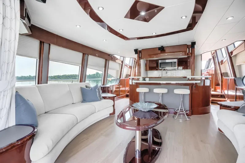 Family Tradition II Yacht Photos Pics Luxurious interior of 2012 Neptunus 750FX yacht with modern furnishings and panoramic windows.