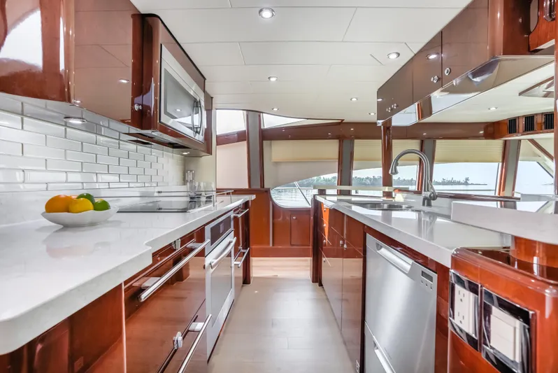 Family Tradition II Yacht Photos Pics Luxurious kitchen interior of 2012 Neptunus 750FX yacht with modern appliances and sleek design.
