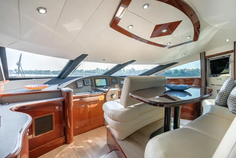 Family Tradition II Yacht Photos Pics Luxurious interior of 2012 Neptunus 750FX yacht with elegant seating and modern dashboard.