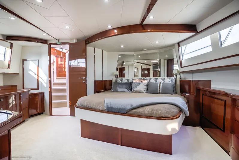 Family Tradition II Yacht Photos Pics Luxurious Neptunus 750FX 2012 yacht bedroom with elegant wood finishes and modern design.