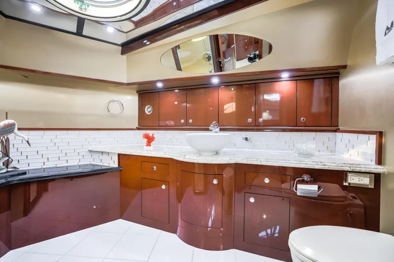 Family Tradition II Yacht Photos Pics Luxurious Neptunus 750FX 2012 yacht bathroom with elegant wood cabinetry and modern fixtures.