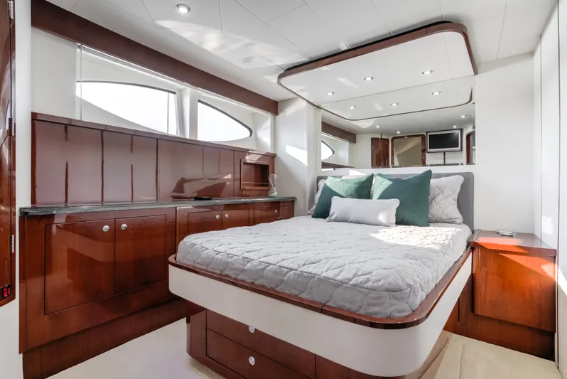 Family Tradition II Yacht Photos Pics Luxurious bedroom interior of 2012 Neptunus 750FX yacht with elegant wood finishes.
