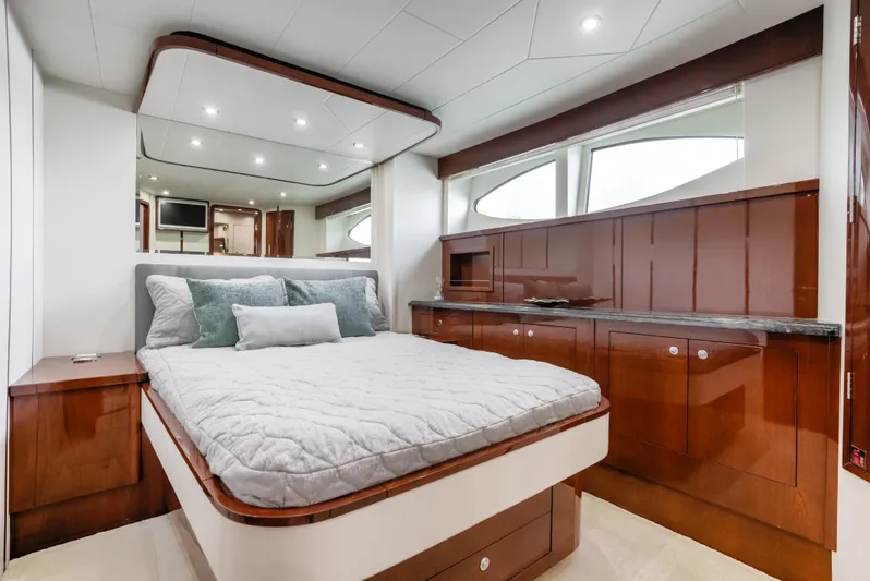 Family Tradition II Yacht Photos Pics Luxurious bedroom interior of 2012 Neptunus 750FX yacht with elegant wood finishes.