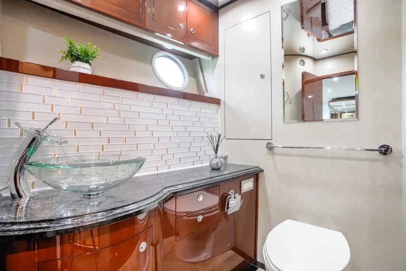 Family Tradition II Yacht Photos Pics Luxurious Neptunus 750FX 2012 yacht bathroom with glass sink and elegant wood cabinetry.