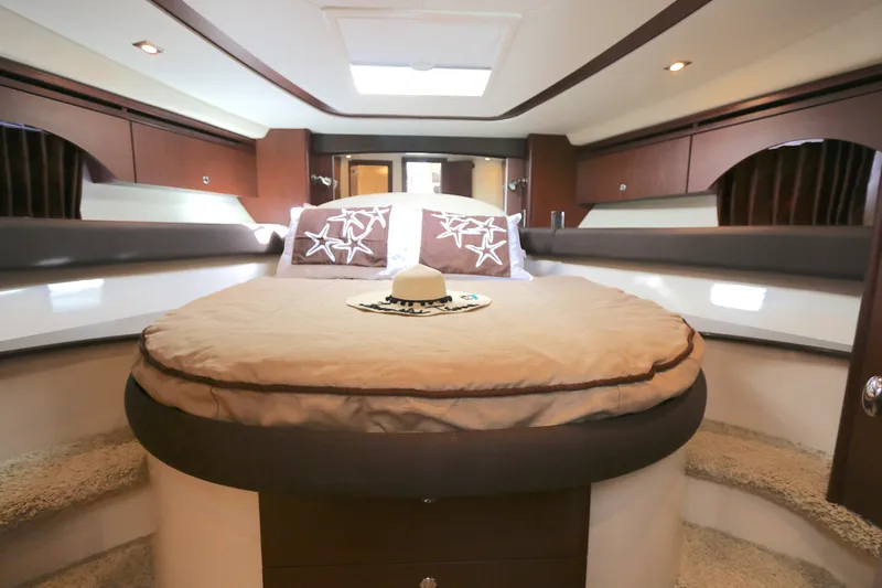 Family Time Yacht Photos Pics Luxurious bedroom interior of 2013 Meridian 441 Sedan yacht with elegant bedding and decor.