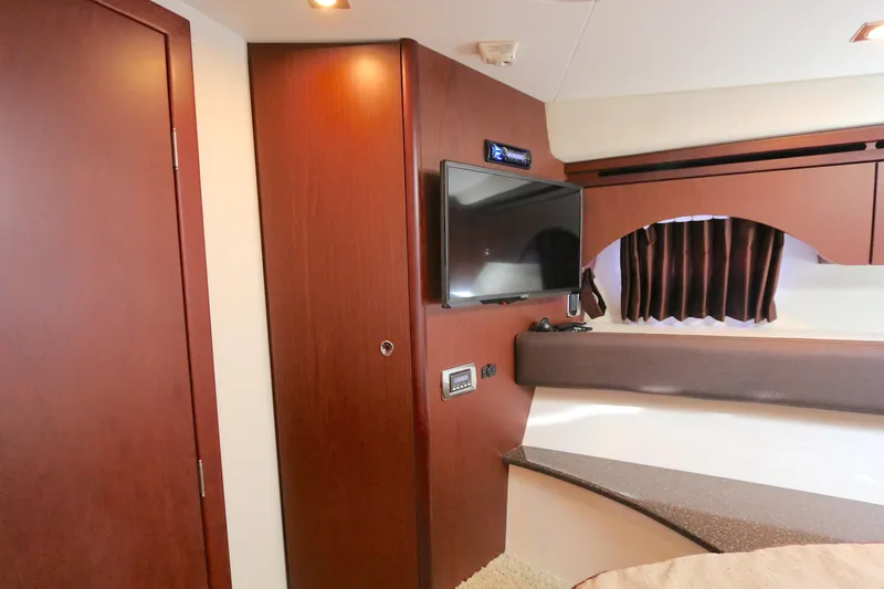 Family Time Yacht Photos Pics Interior of 2013 Meridian 441 Sedan with wood paneling and mounted TV.