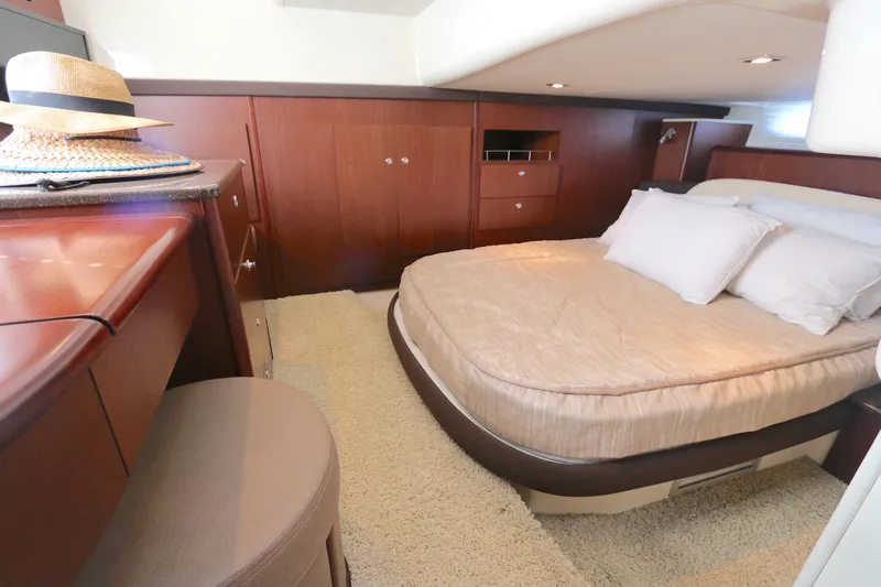 Family Time Yacht Photos Pics Luxurious bedroom interior of 2013 Meridian 441 Sedan yacht with elegant wood finish.