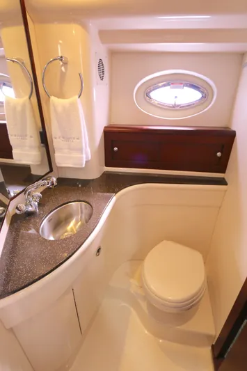 Family Time Yacht Photos Pics Luxurious bathroom in 2013 Meridian 441 Sedan yacht with sink, toilet, and porthole.