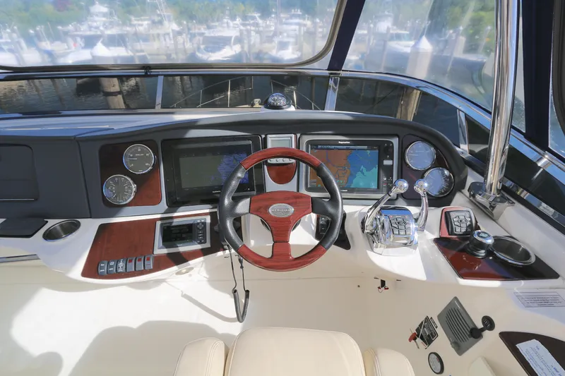 Family Time Yacht Photos Pics Cockpit of 2013 Meridian 441 Sedan yacht with advanced navigation controls and steering wheel.