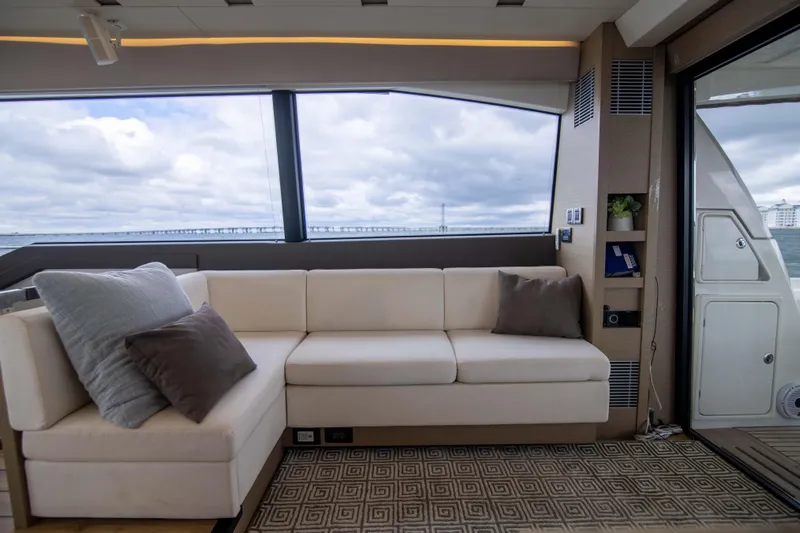 Prestige Worldwide Yacht Photos Pics Luxurious interior of 2018 Prestige 680 Flybridge yacht with plush seating and ocean view.