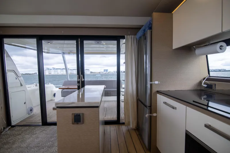 Prestige Worldwide Yacht Photos Pics Interior of 2018 Prestige 680 Flybridge yacht with modern kitchen and ocean view.