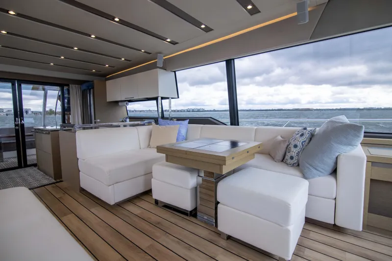 Prestige Worldwide Yacht Photos Pics Luxurious interior of 2018 Prestige 680 Flybridge yacht with elegant seating and ocean view.