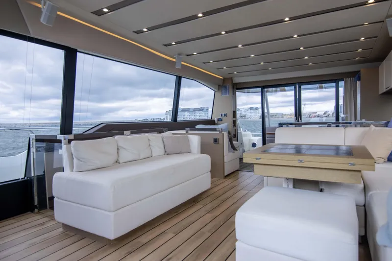 Prestige Worldwide Yacht Photos Pics Luxurious interior of 2018 Prestige 680 Flybridge yacht with modern seating and panoramic windows.