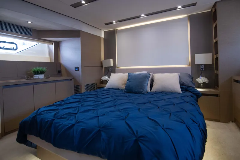 Prestige Worldwide Yacht Photos Pics Luxurious bedroom in 2018 Prestige 680 Flybridge yacht with modern decor and blue bedding.