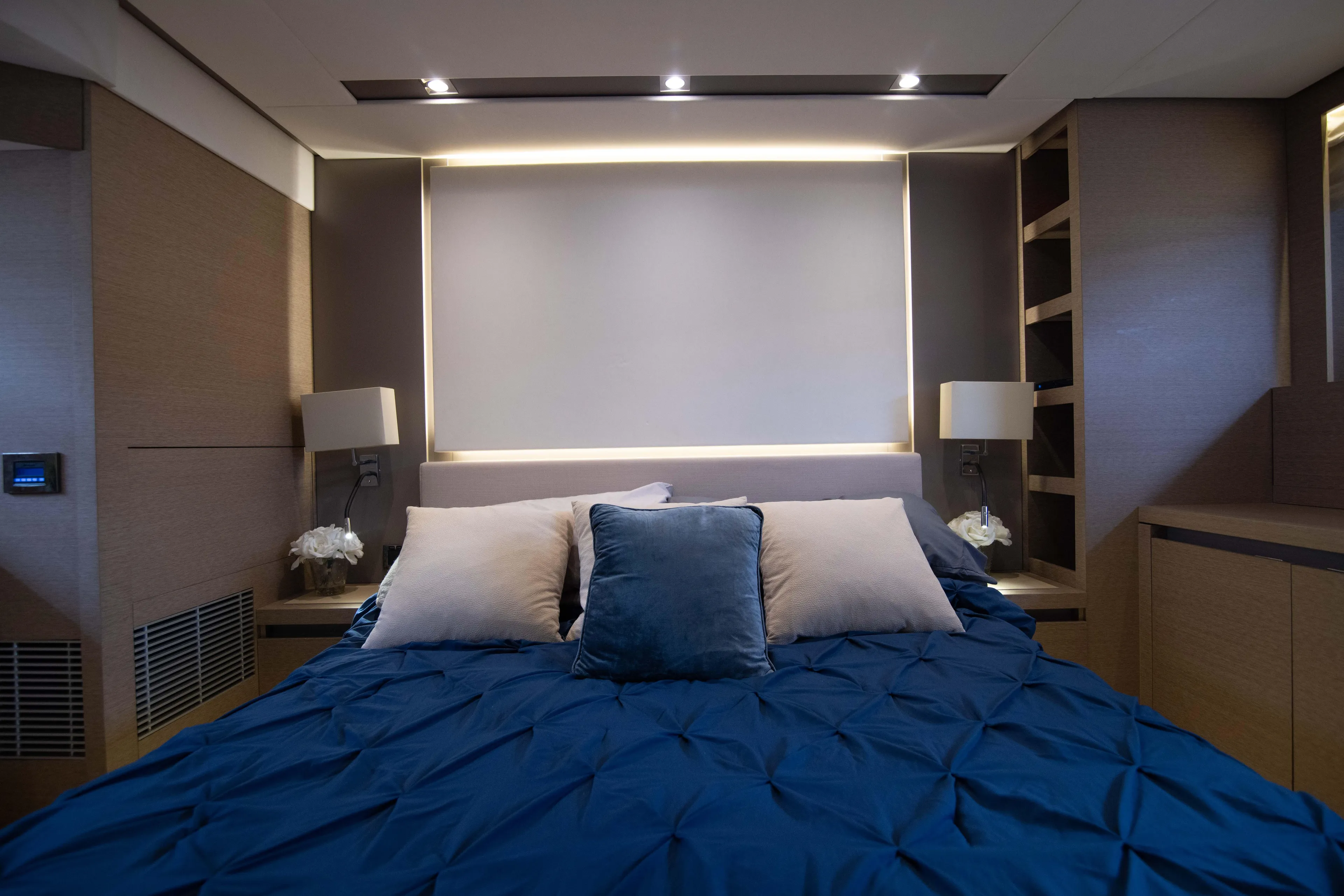 Prestige Worldwide Yacht Photos Pics Luxurious bedroom interior of 2018 Prestige 680 Flybridge yacht with blue bedding.