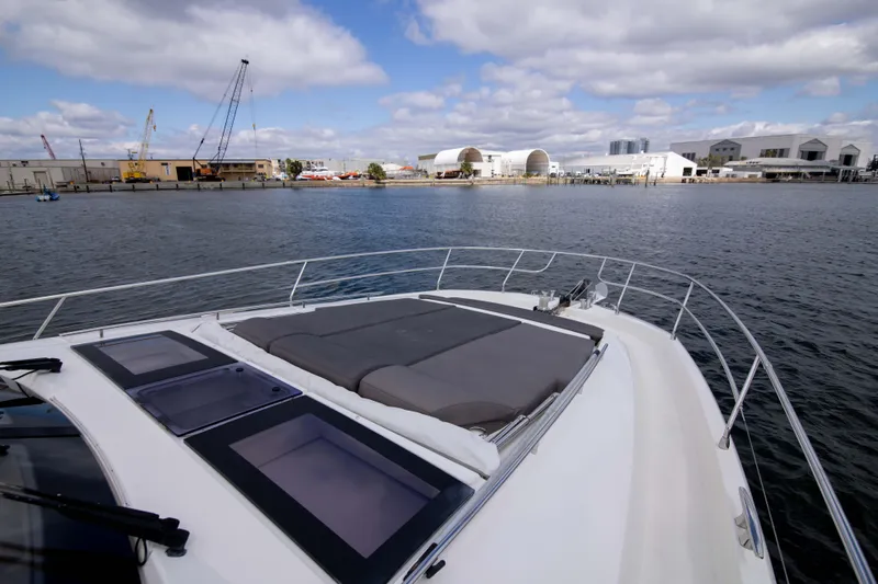 Prestige Worldwide Yacht Photos Pics Prestige 680 Flybridge 2018 yacht on water with industrial background.