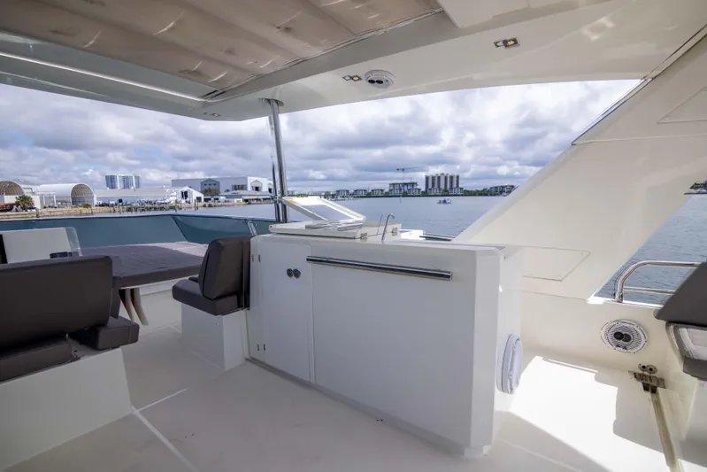 Prestige Worldwide Yacht Photos Pics Prestige 680 Flybridge 2018 yacht interior with waterfront view, featuring sleek seating and cabinetry.
